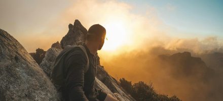 Guy sitting on mountain watching sunset - how to recover from a porn addiction